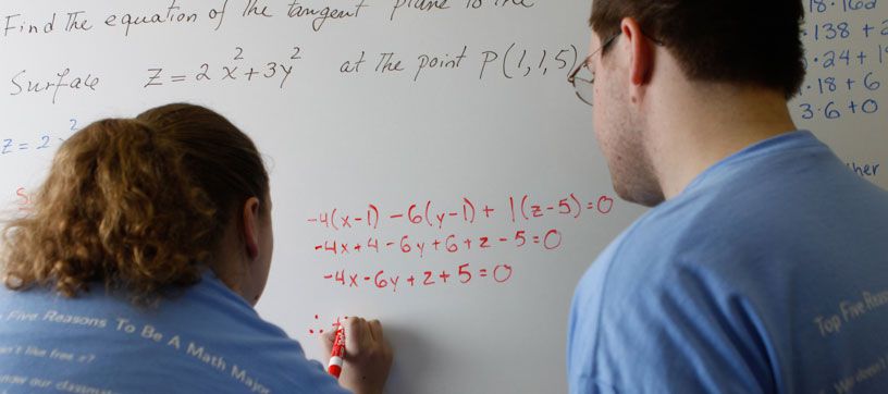 Math students working on equations together