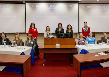 Society of Women Engineers members pose with CNU students.