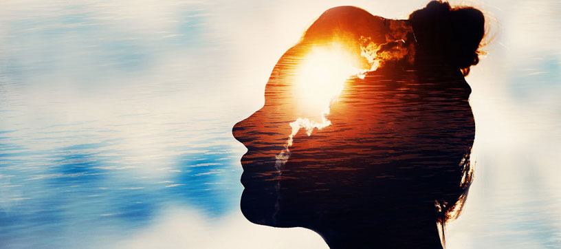 Woman's head in silhouette with sky