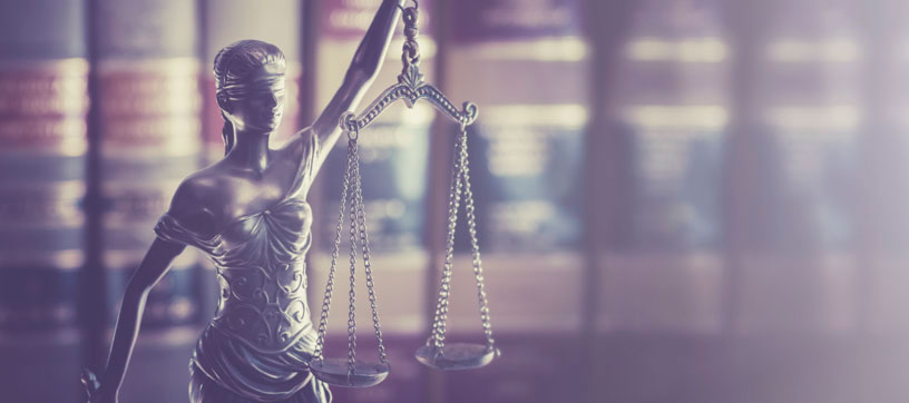 Statue of Justice with books