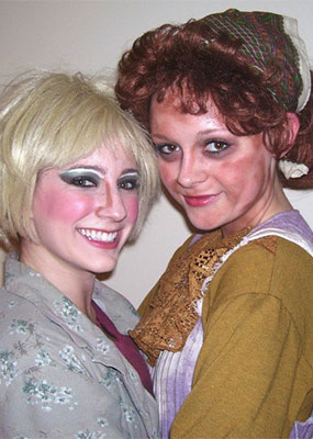 Two theatre students in costumes and makeup for a production of Urinetown.