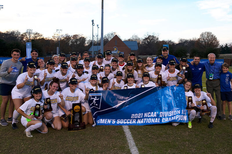 CNU women's soccer team with a 2021 championship banner