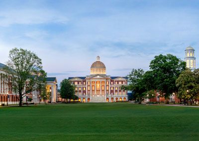 Evening at the great lawn grassy area of Christopher Newport, which is bordered by Forbes Hall, Luter Hall, Christopher Newport Hall, Trible Library and David Student Union