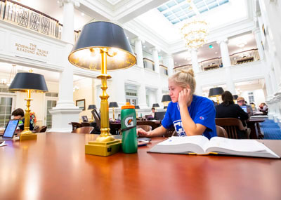 Female student studying in the Trible Library reading room