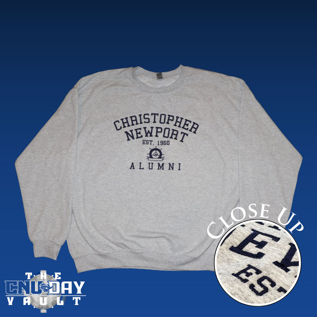 Gray crewneck sweatshirt featuring a navy embroidered alumni seal