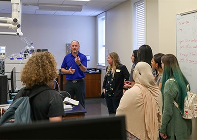 Students from VPCC listen to a professor talking in a biology lab