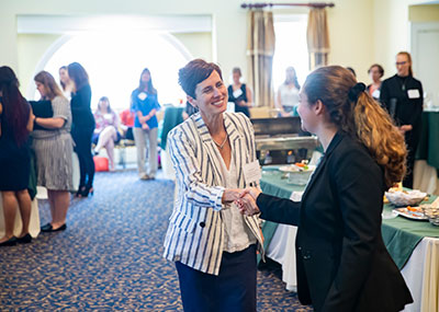 Dr. Lisa Monaco (left) greets senior Carly Wever