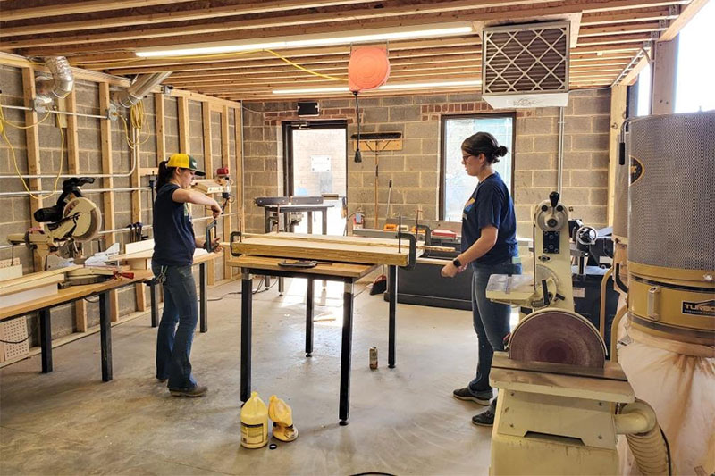 Cheyanne Dwyer ’16, left, and Cecily Wynne ’17 build wooden molds used to produce emergency face masks.