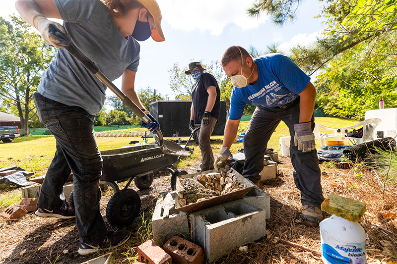 Dr. Russell Burke (right) and students build artificial reef components