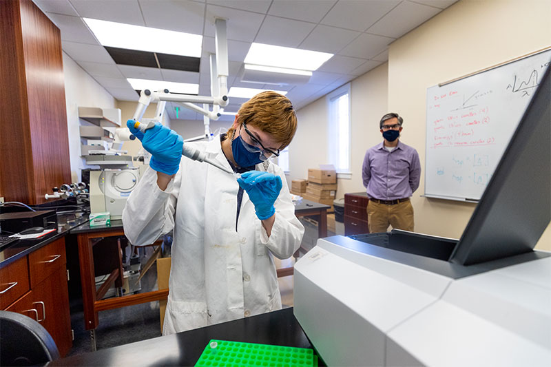 Madeline Clark tests a sample in the chemistry lab