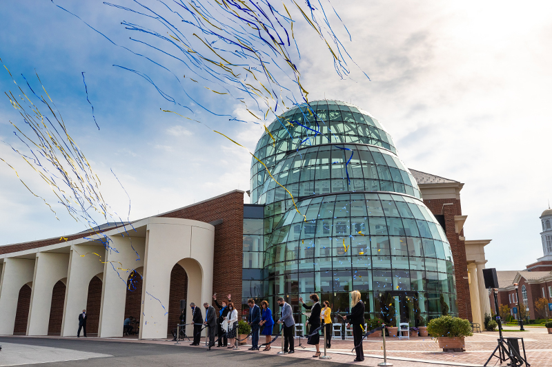 Confetti and streamers fly as the ribbon is cut at the soft opening for the Mary M. Torggler Fine Arts Center.