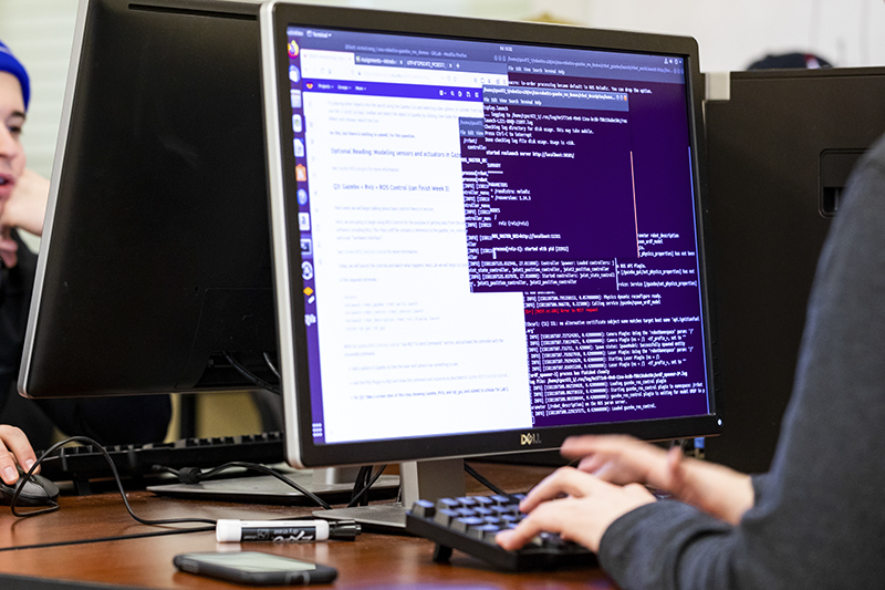 A student codes in the CNU robotics lab