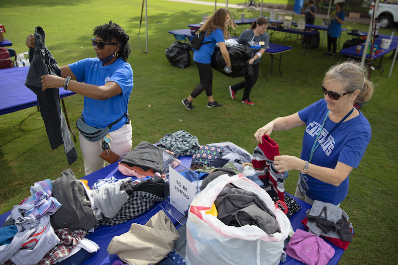 2 women sort clothes on the Great Lawn