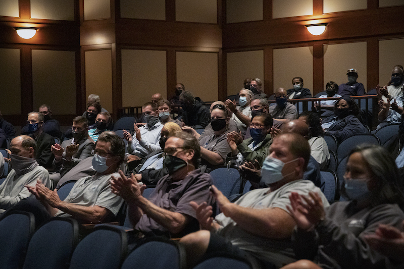 Employees applaud the wage increase announcement