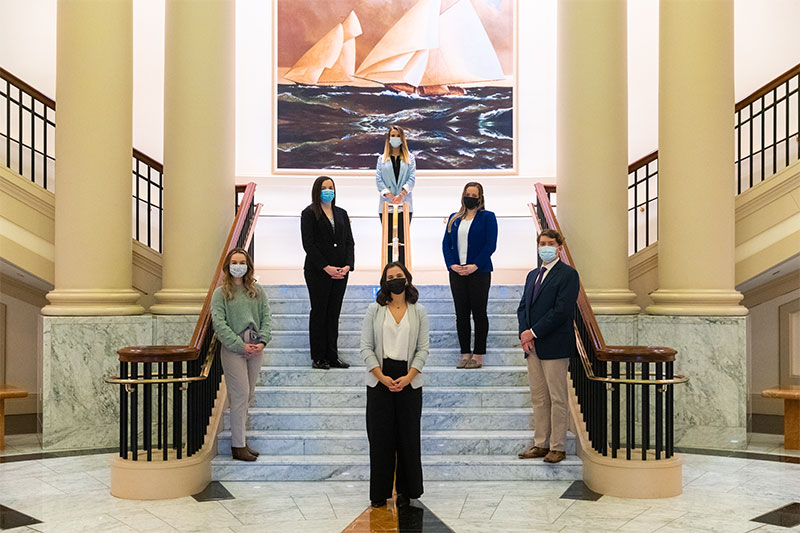 Six leadership studies majors on the Trible Library rotunda steps