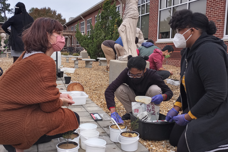 Dahria Kalmbach and students at An Achievable Dream Academy prepare Atlantic white cedar seedlings for study.