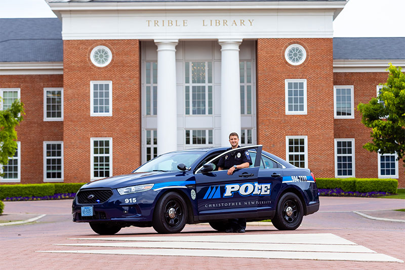 CNUPD Officer Caden Butler in front of Trible Library