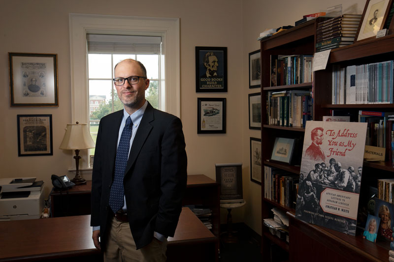 Professor Jonathan White Stands in his office