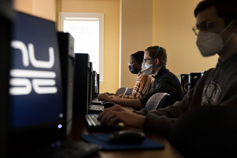 Photo of students working at computers in the Hunter Creech lab