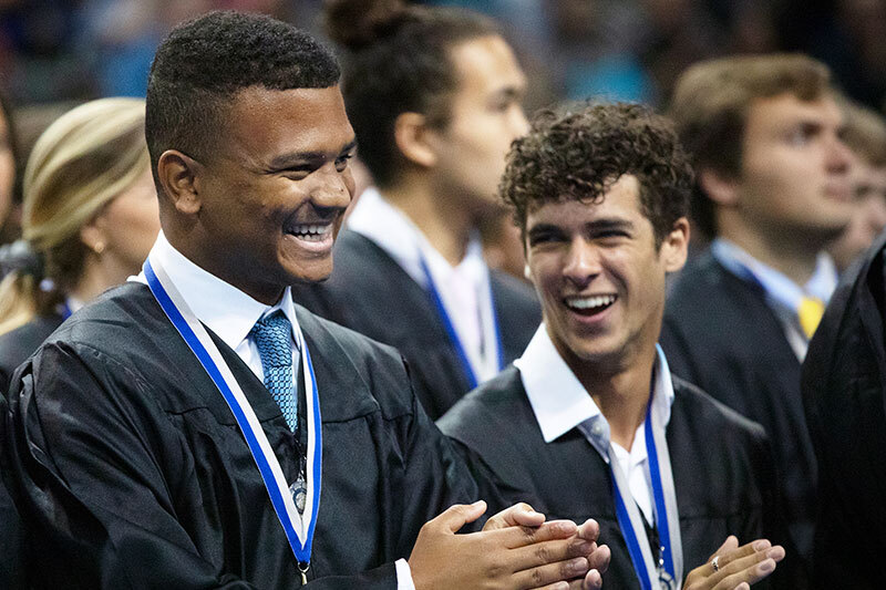 Two students smiling at Latin Honors Convocation.