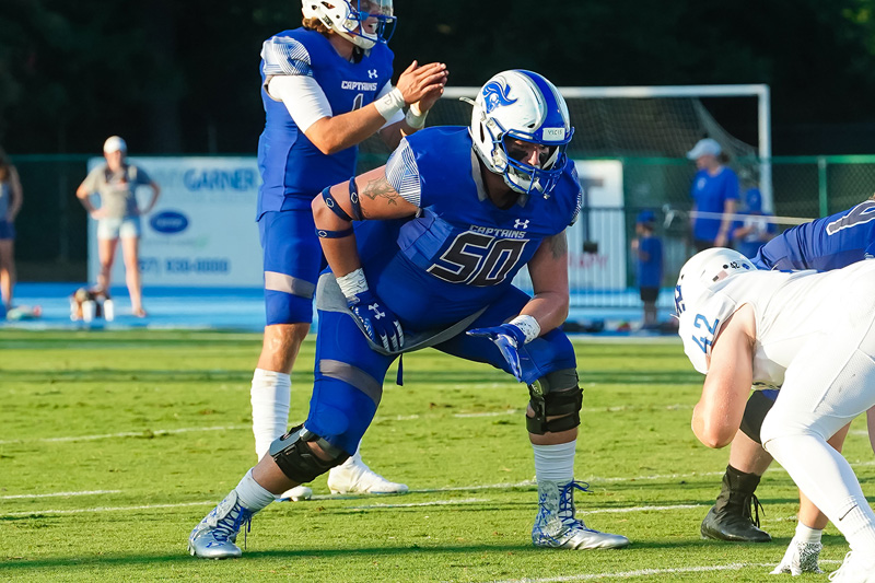 Anthony Atkins lines up at the line of scrimmage wearing the number 50 blue CNU football uniform.
