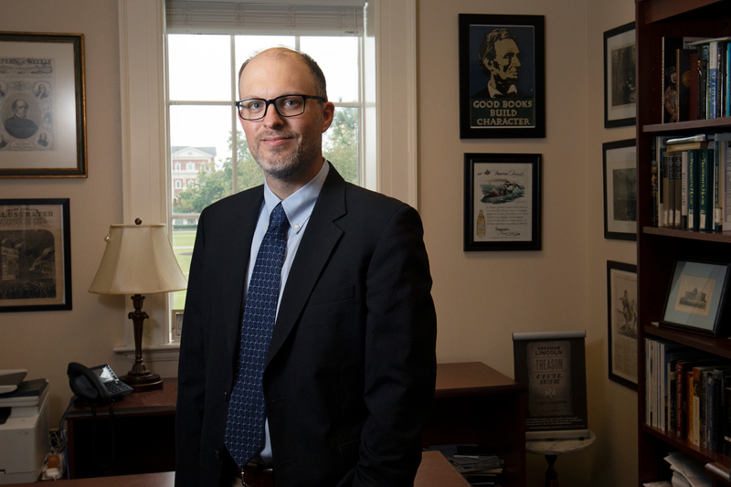 Portrait of Jon White standing in his office