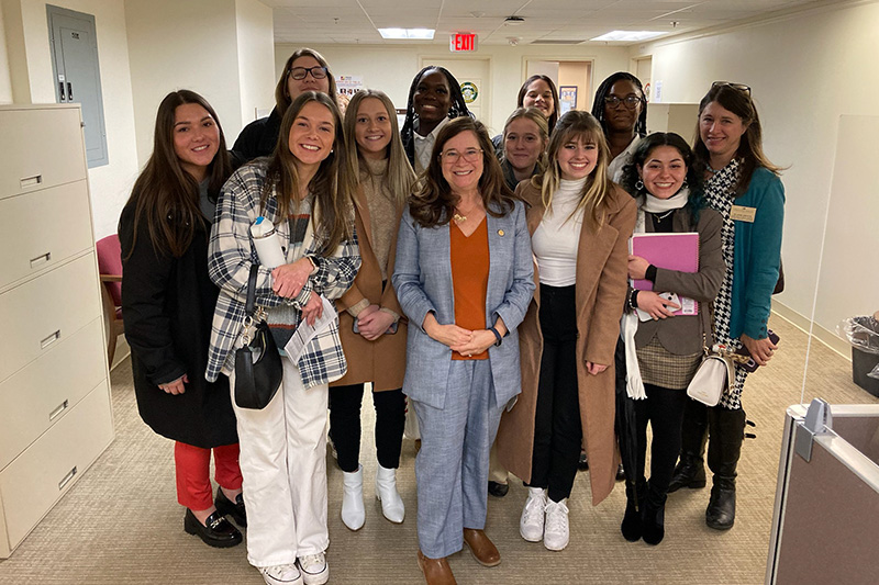 Virginia Delegate Shelly Simonds stands with a group of Christopher Newport students visiting the General Assembly in Richmond.