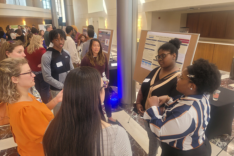 Students present their poster board to teachers and other students.