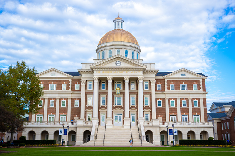Christopher Newport Hall stands tall in front of a blue sky.