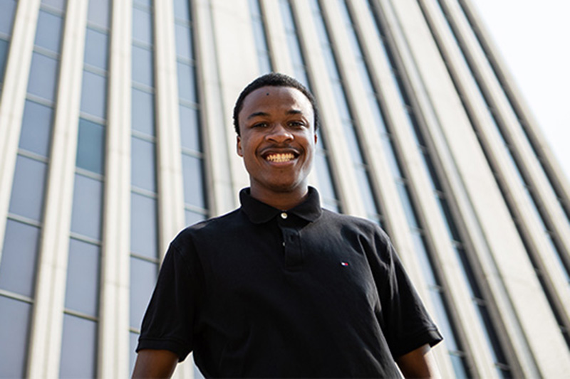 Patrick Lassiter '25 stands in front of Newport News' City Hall building.