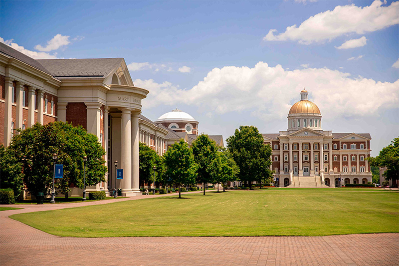 A wide view of Christopher Newport's Great Lawn with Christopher Newport Hall in the background and Forbes hall presented on the left side of the image.