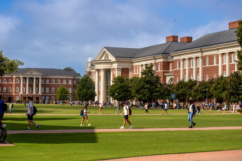 Wide shot of CNU's campus with students walking.