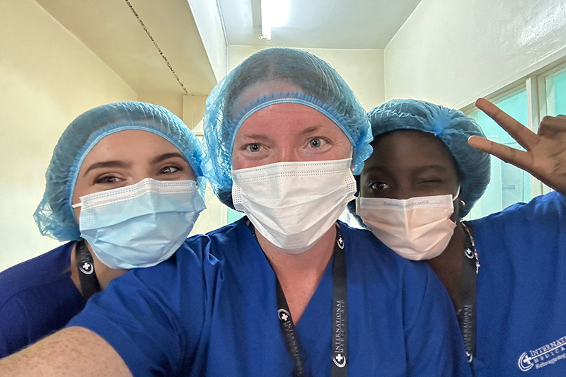 Christina Richardson '25, right, takes a selfie with medical personnel.