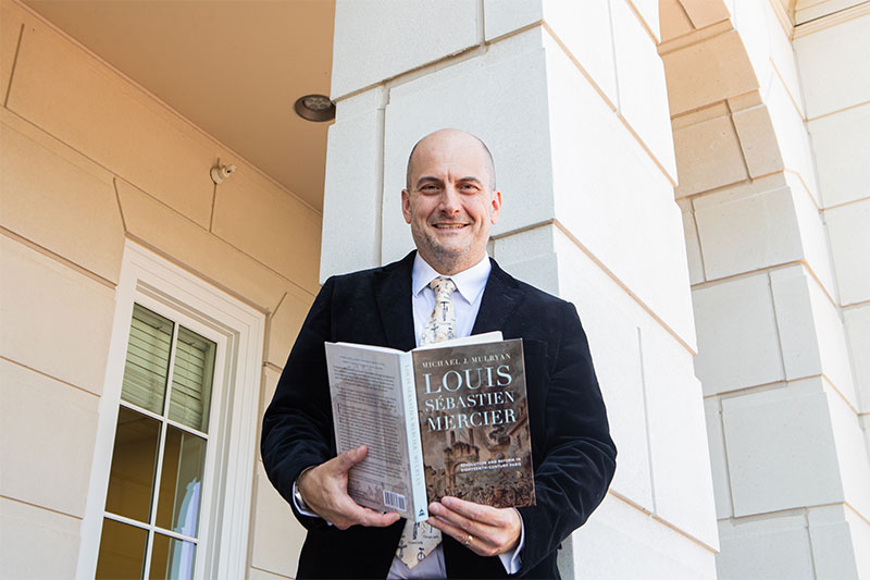 Dr. Michael Mulryan holds his book on Louis Sebastien Mercier.