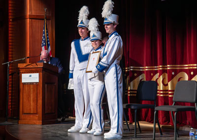 Marching Captains in uniform accept their invitation to the London New Year's Day parade on stage.