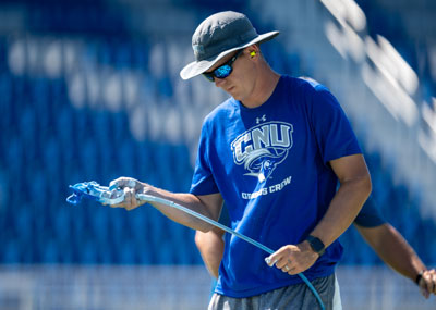 Chris Webb holds a spray painting nozzle.