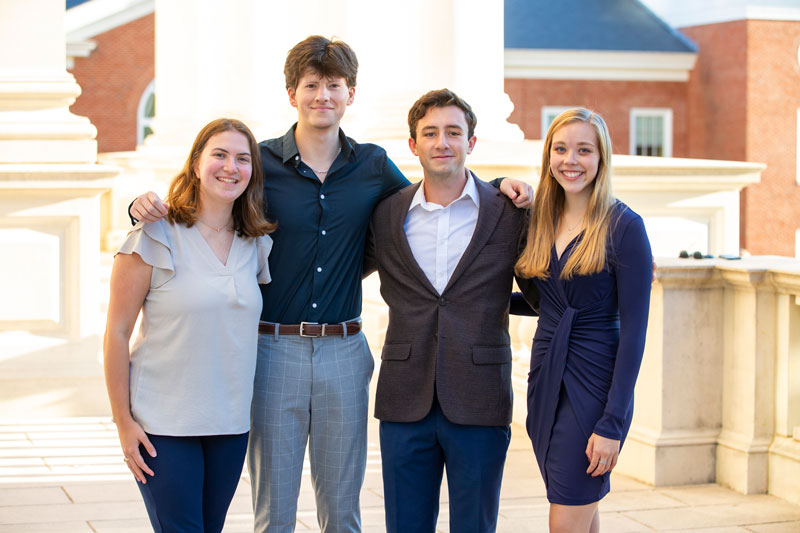 CNU President's Leadership Program students part of 'Team Silver' gather in business attire to pose for a photo.