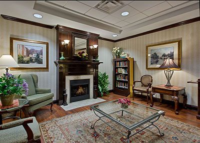 Country Inn and Suites interior lobby with chairs and a fireplace