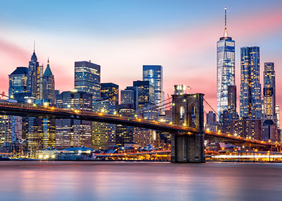 New York City skyline and Brooklyn Bridge at dusk