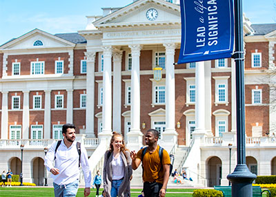 Three Students walking with each-other in front of the CNU Building 