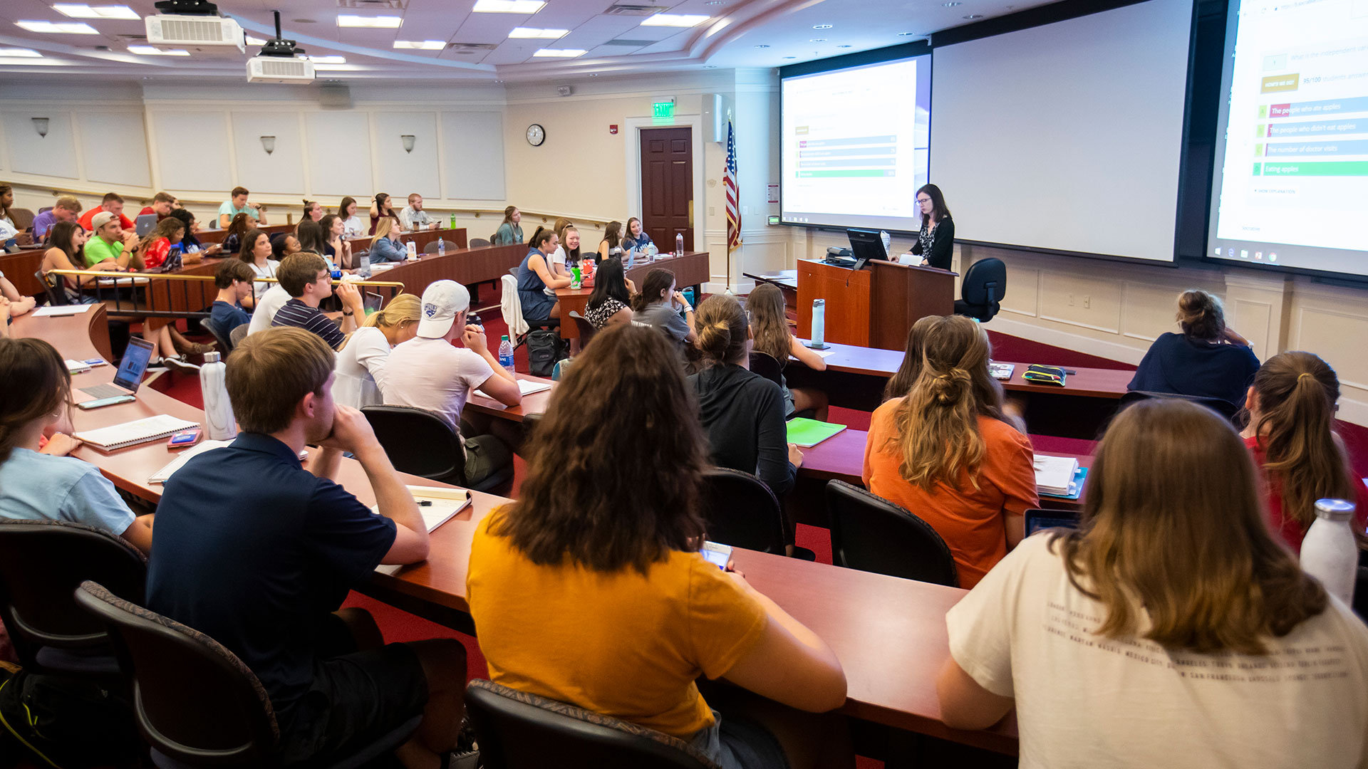 Students in a lecture hall listen to a professor