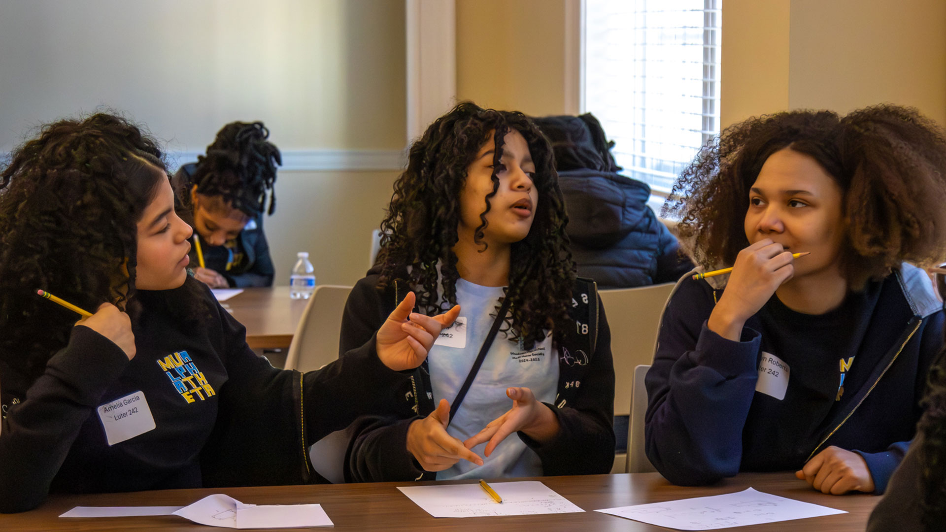 A group of girls discuss math problems at the annual Regional Math Contest at CNU