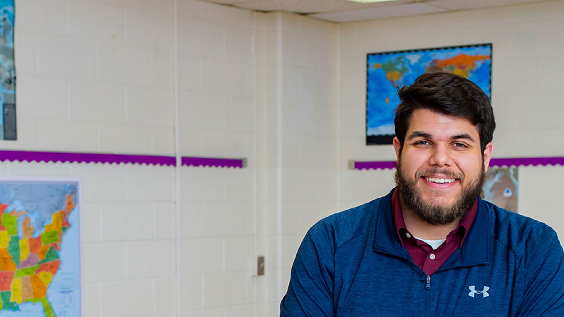 Richard Long, MAT graduate, sits in a classroom.