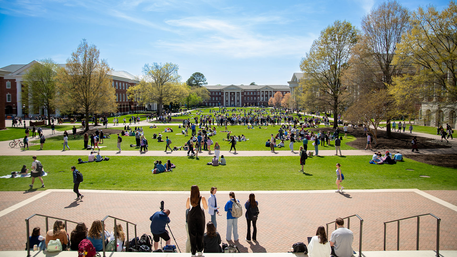 A view of the Great Lawn from Christopher Newport Hall as students enjoy sunny weather.