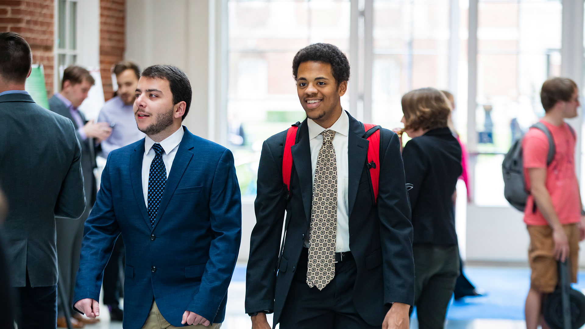 Students in suits walking through the DSU