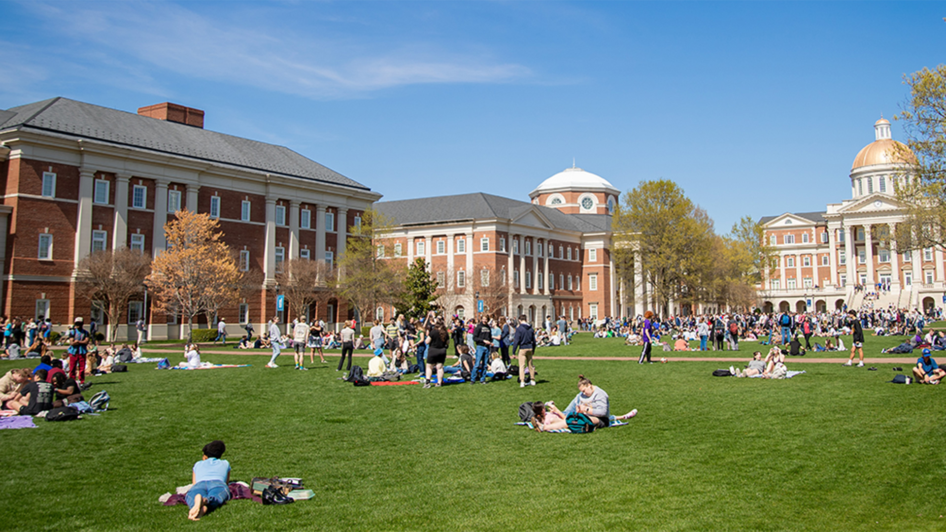 Students laying on the Great Lawn enjoying spring weather