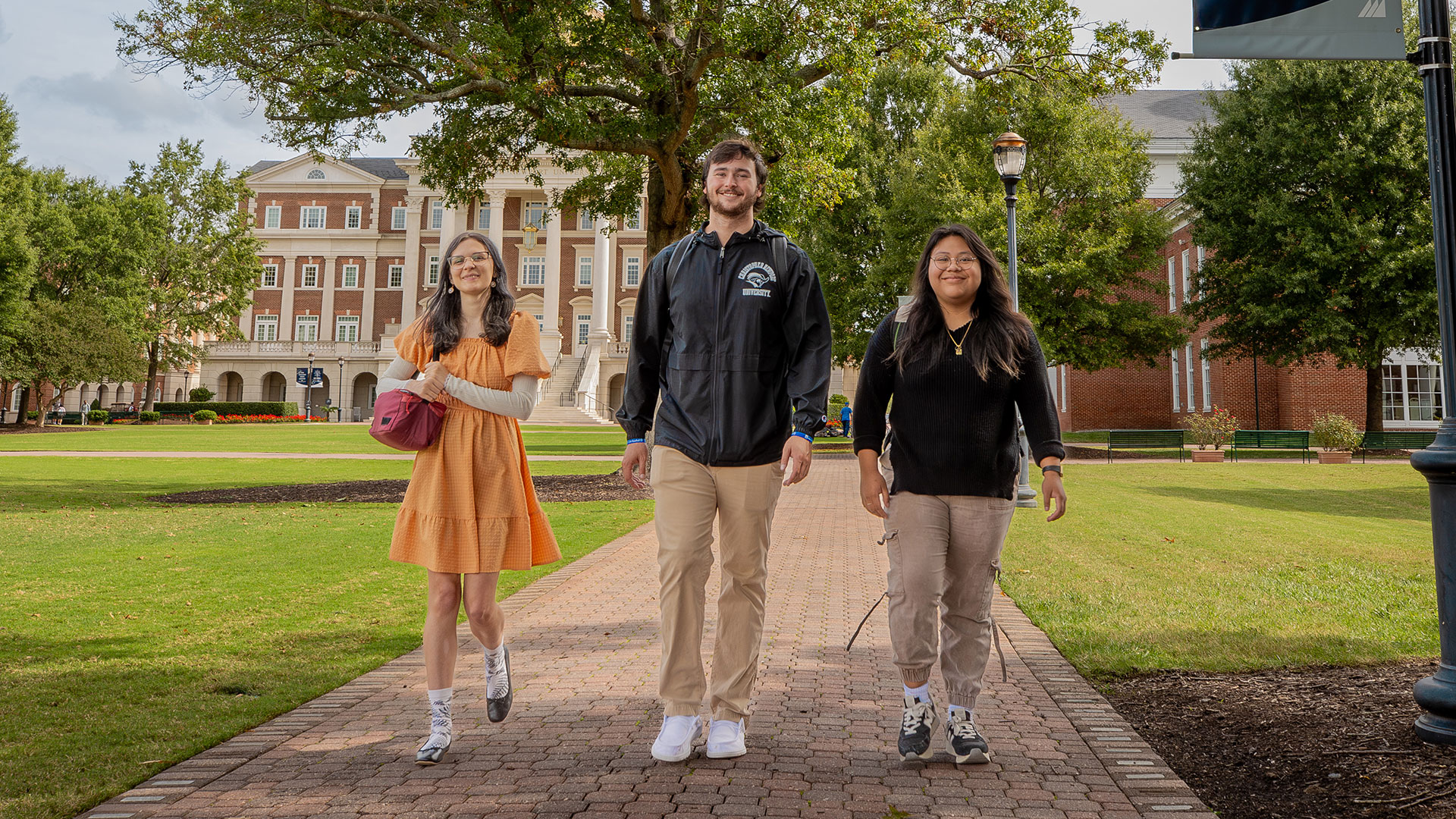 Transfer students walk beside the Great Lawn