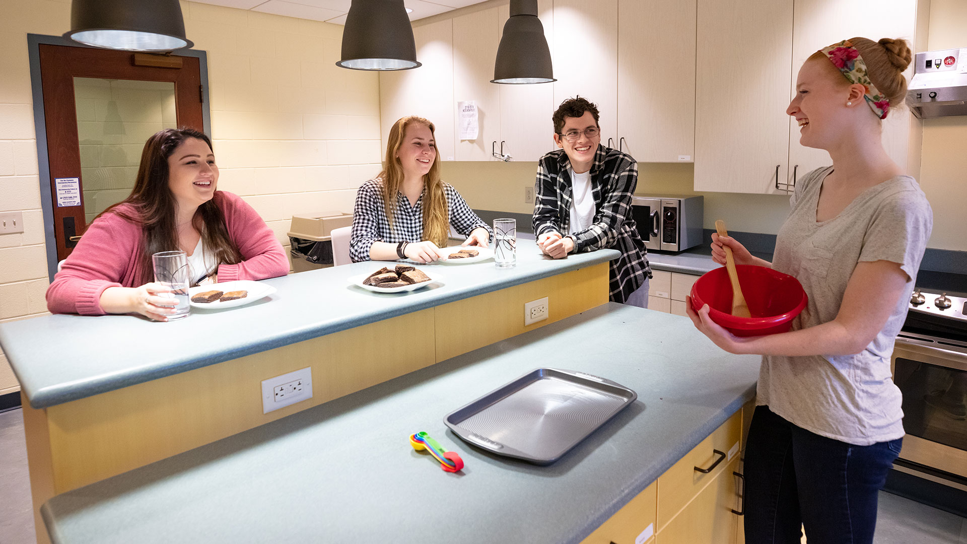 Students in Warwick Hall enjoying cookies in the kitchen