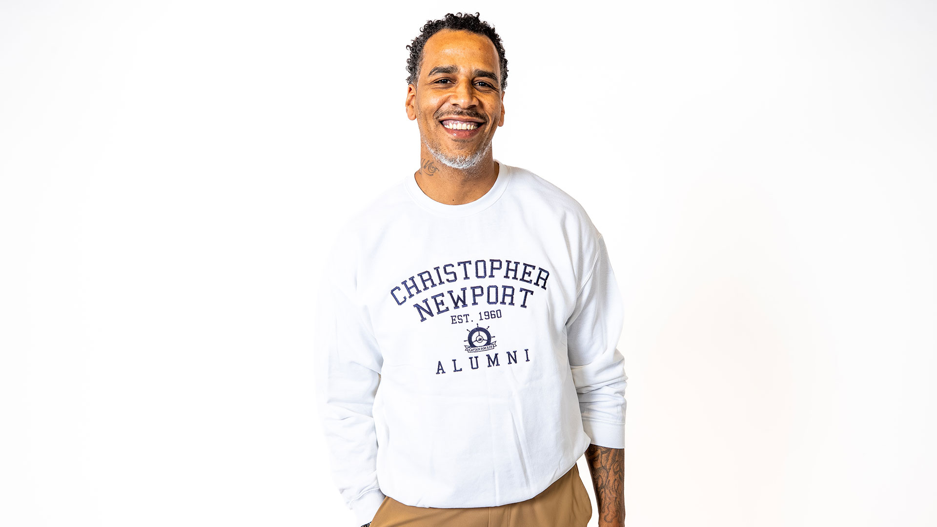 A mean wears a white sweatshirt against a white background