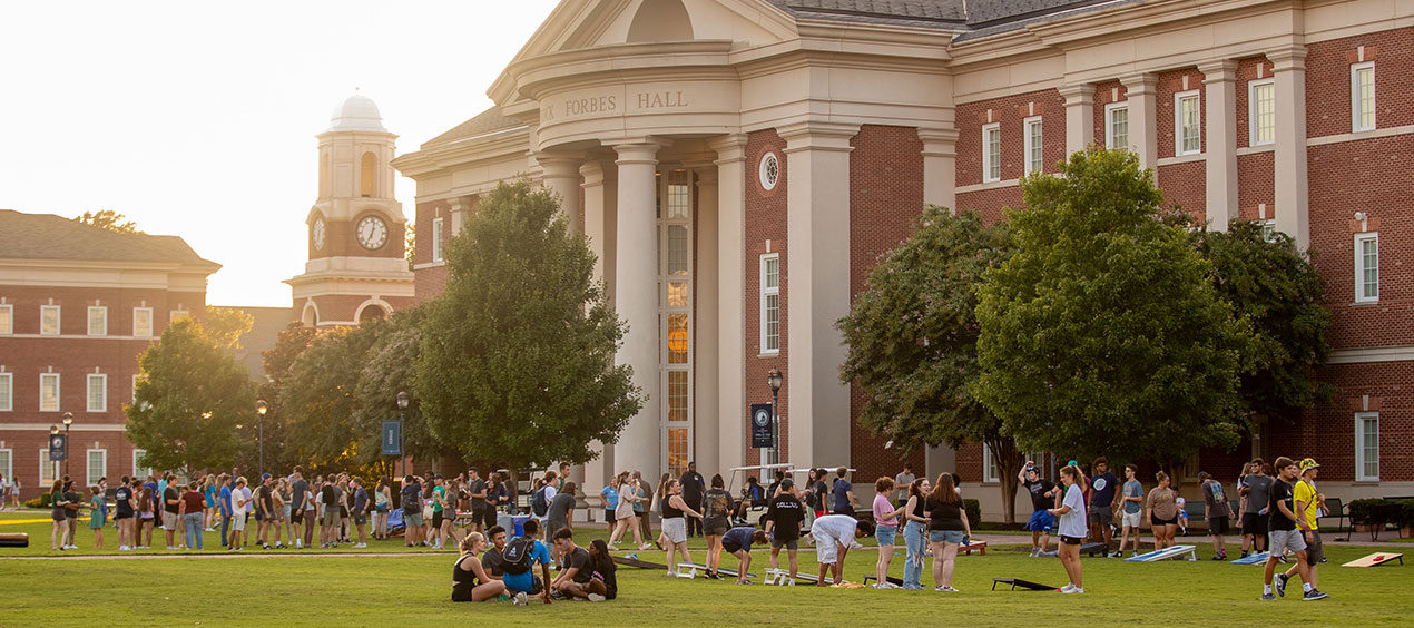 Students gathered on the Great Lawn at sunset